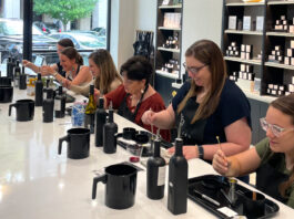 Six people participate in a candle-making workshop