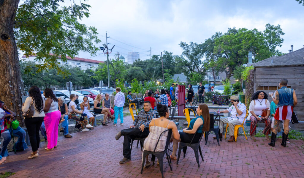 People sitting in groups chatting outside of Art League Houston