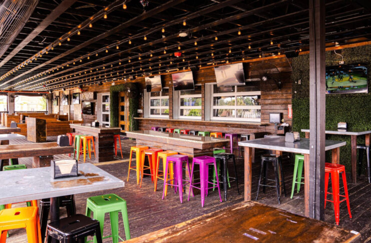 The covered outdoor patio at Prospect Park with rows of colorful seating