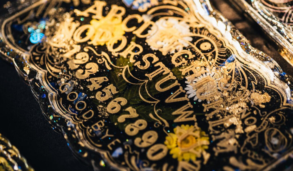 A close up of a tray featuring a Ouija board design