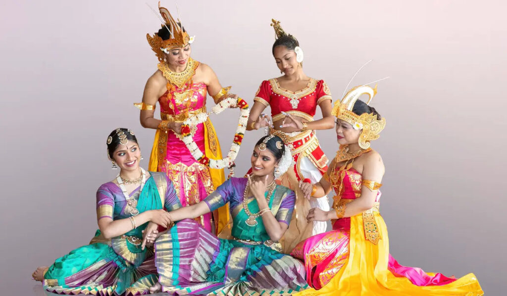 A promotional image featuring female dancers in colorful garments