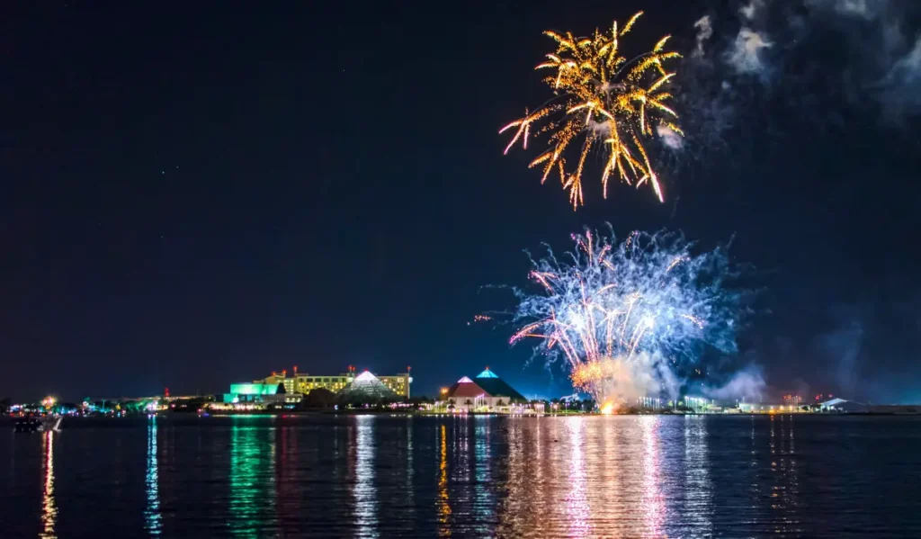 The Moody Gardens pyramids from a distance with a fireworks show above them