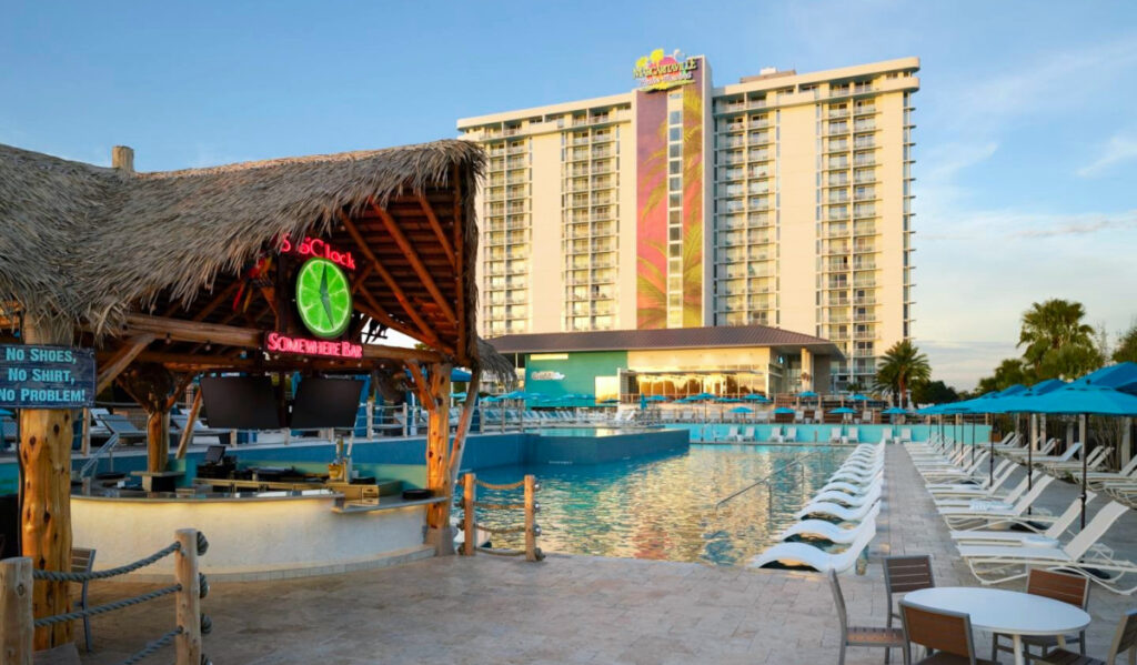 The pool grounds of Margaritaville Resort with a tiki bar and lounge seating