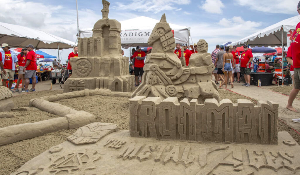 Sand sculptures of a knight riding a horse and a castle, along with lettering that says 'Ironman'