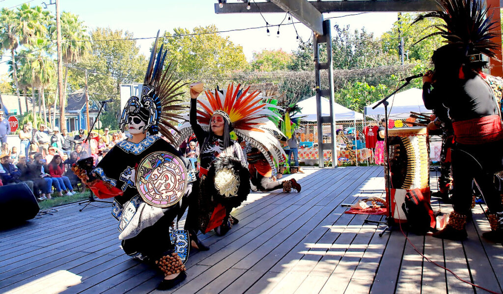 Performers in colorful Aztec costumes perform traditional dances