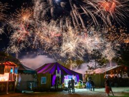 Fireworks go off above a market