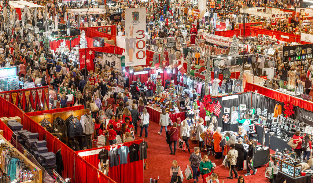 A massive market with crowds moving around holiday decor booths