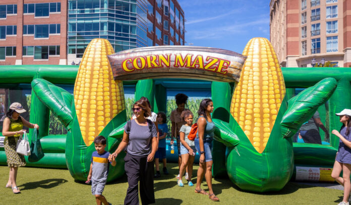 Families emerge from an inflatable Corn Maze exit