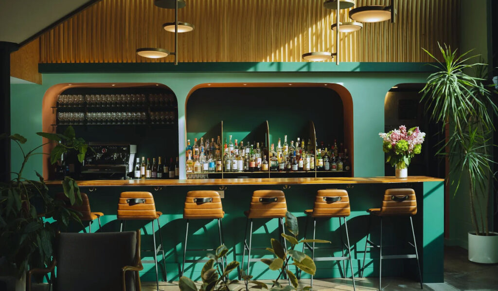 A bar surrounded by plants and in natural light