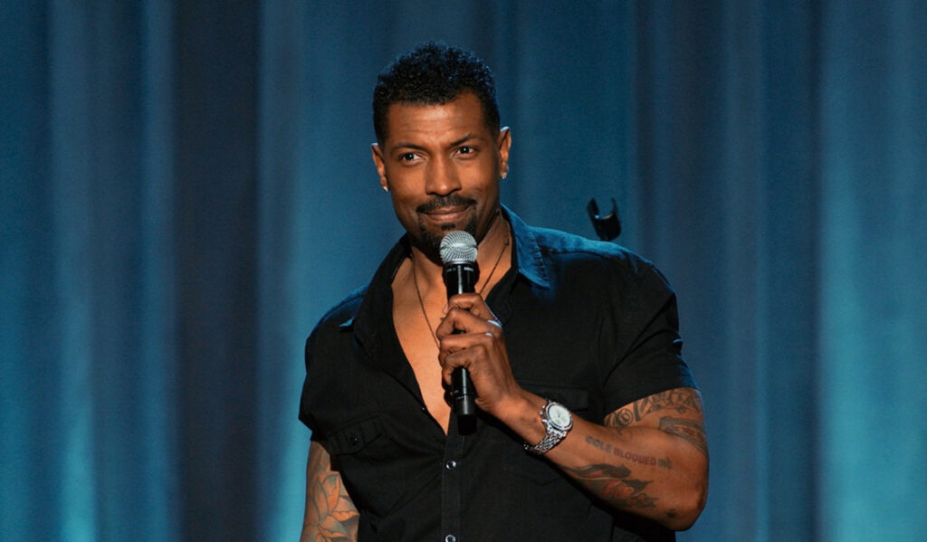 Comedian Deon Cole performing on stage