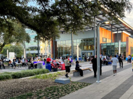 People gathered at Emancipation Park near a building