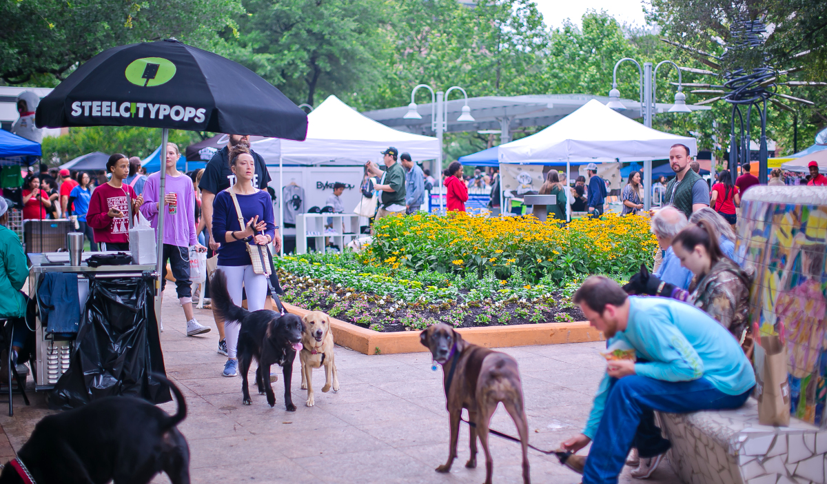 People and dogs strolling through a morning market