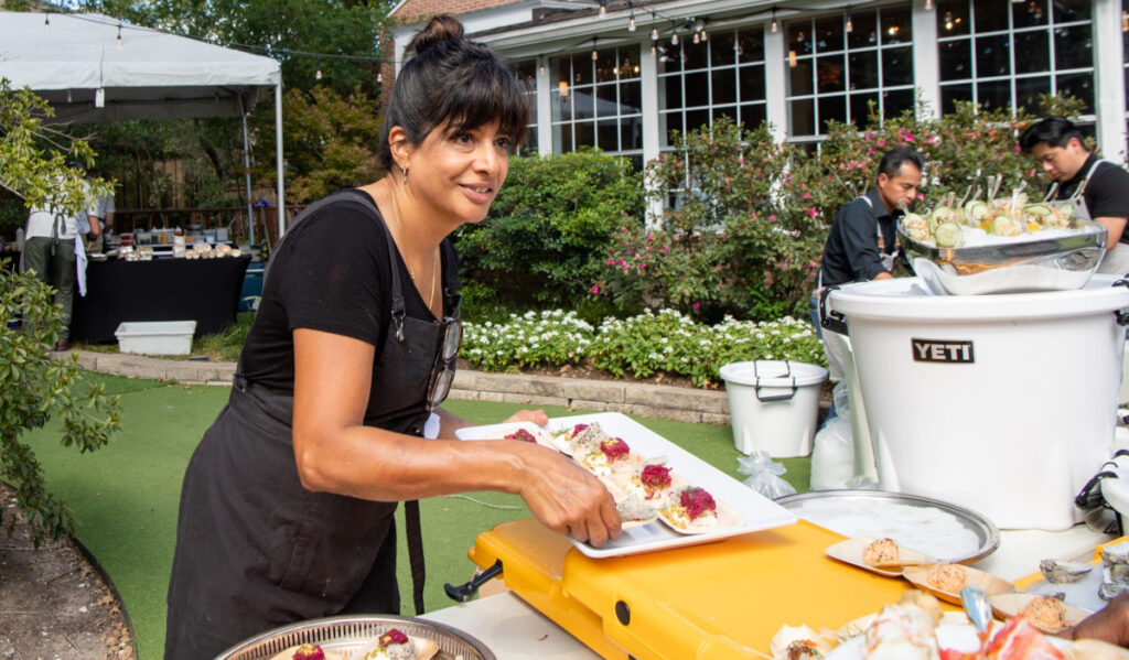 Chef Cheetie Kumar prepares to serve guests at a food tasting event
