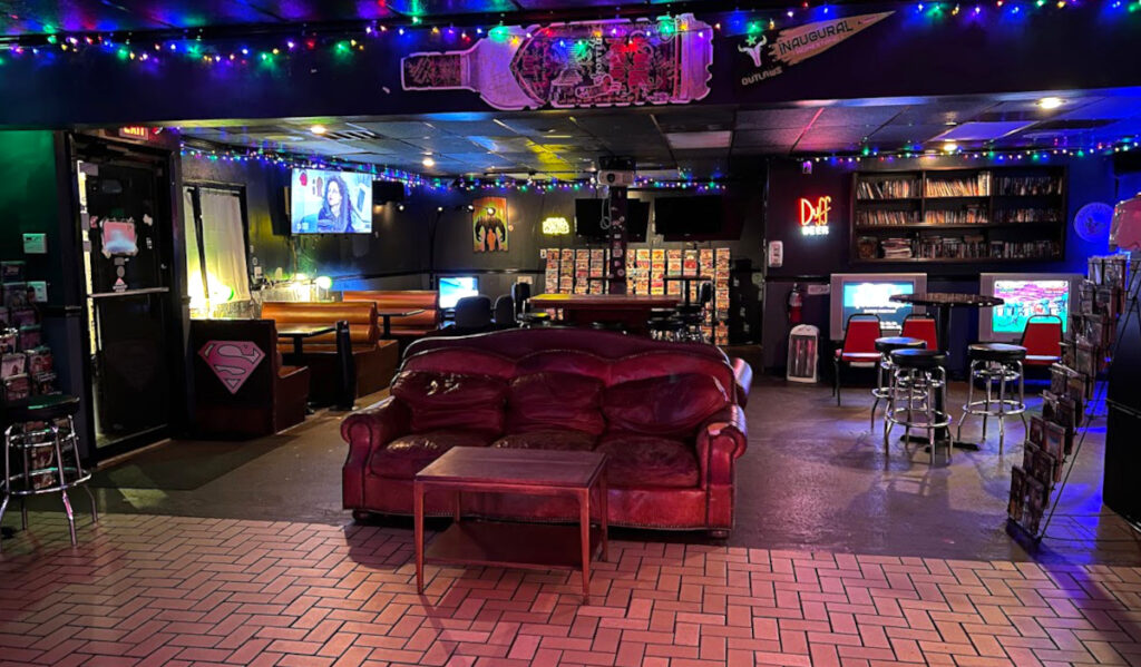 Interior of Neil's Bahr with couch, comics and arcade games