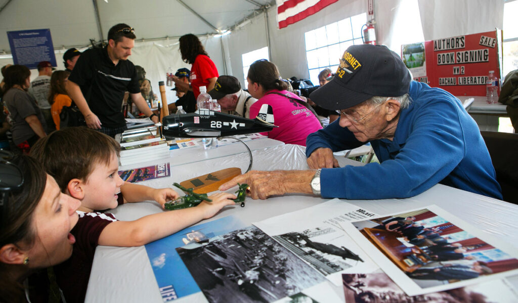 A war veteran talks with a child about a toy helicopter