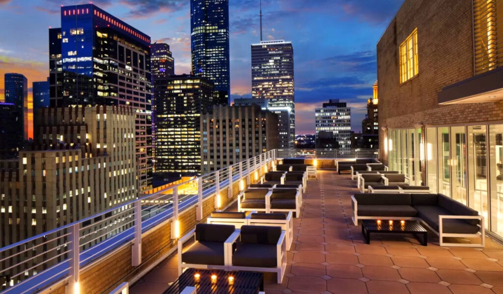 A rooftop patio at sunset among the Downtown skyscrapers