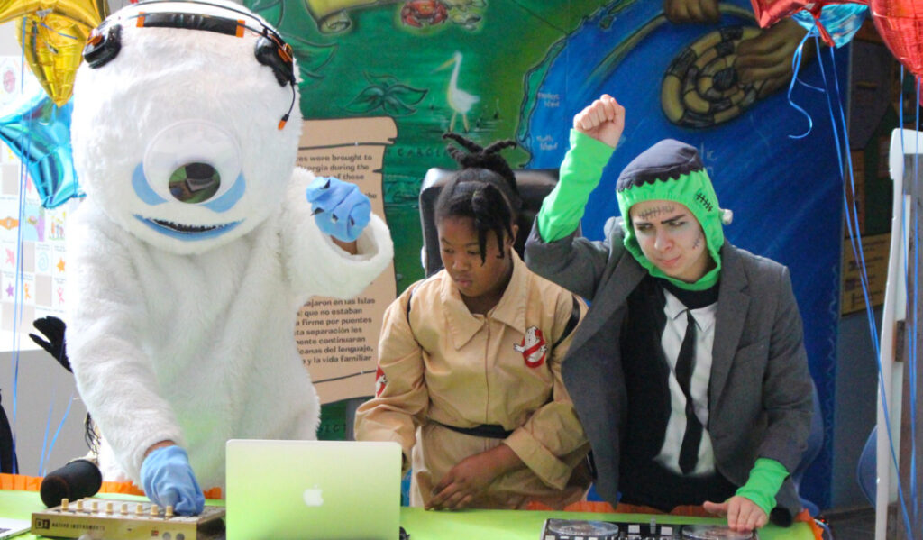 DJs performing in a yeti costume, a Ghostbusters costume and a Frankenstein costume