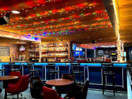 Interior of Marquis II with lights on the ceiling and an empty bar