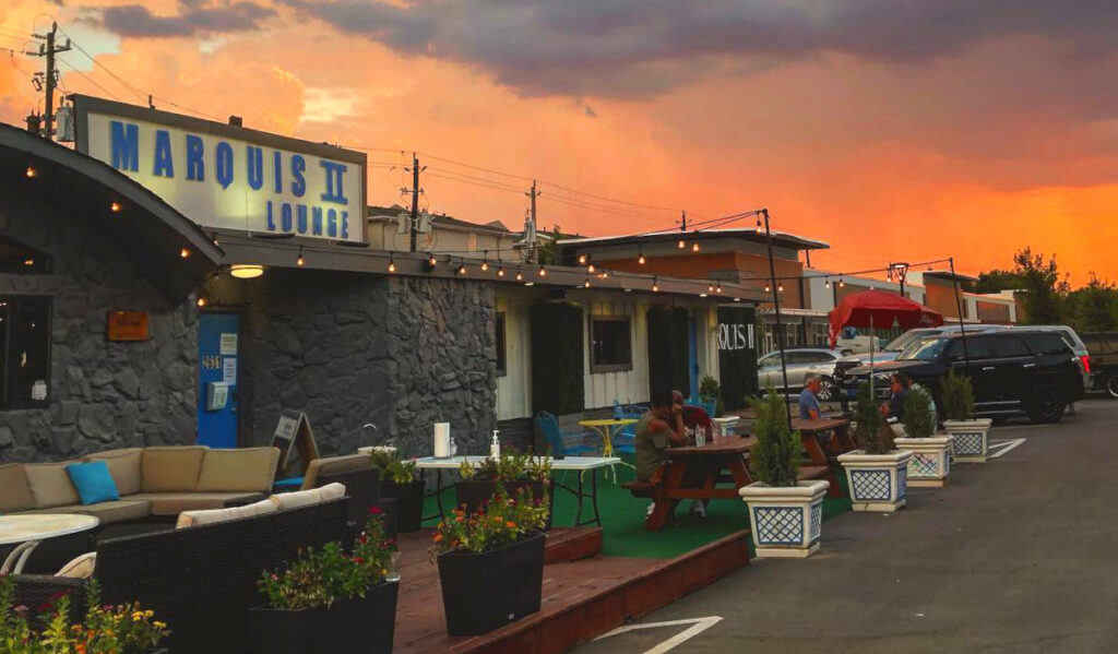 Exterior of Marquis II with a bright orange sunset