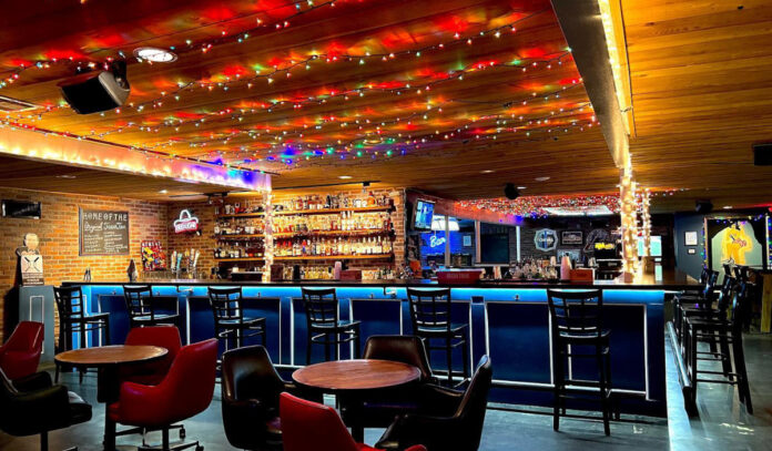 Interior of Marquis II with lights on the ceiling and an empty bar