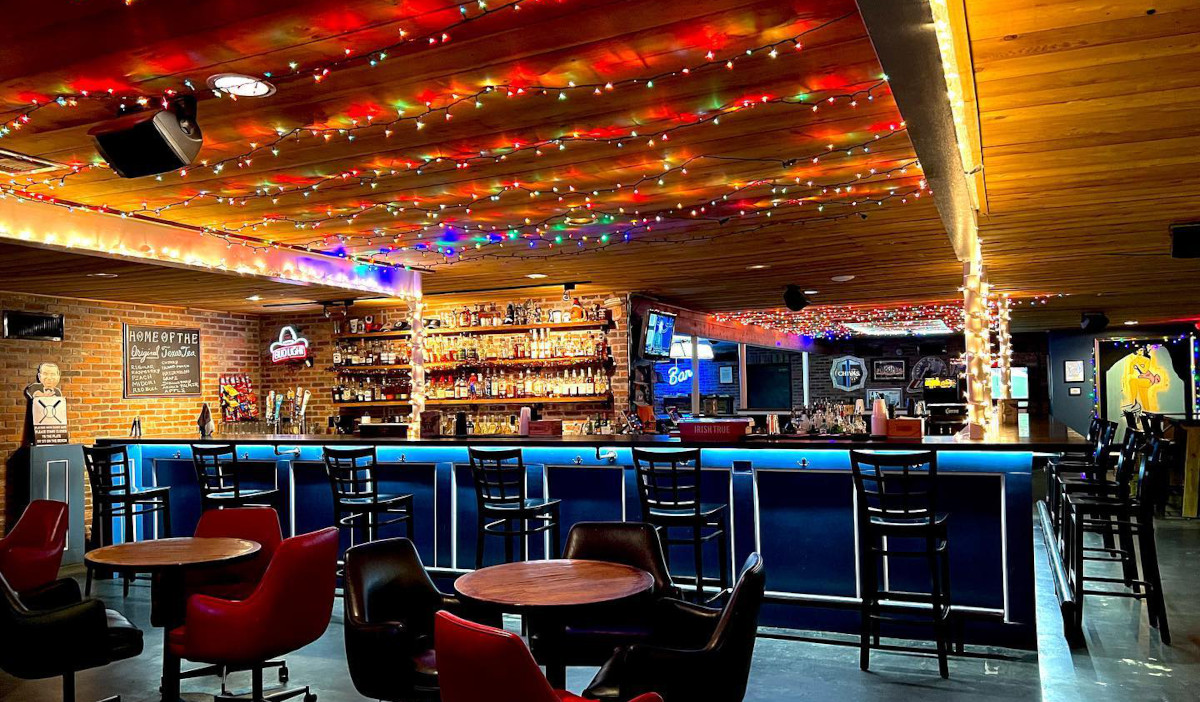Interior of Marquis II with lights on the ceiling and an empty bar