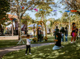 Kids playing on grass at a Day of the Dead festival