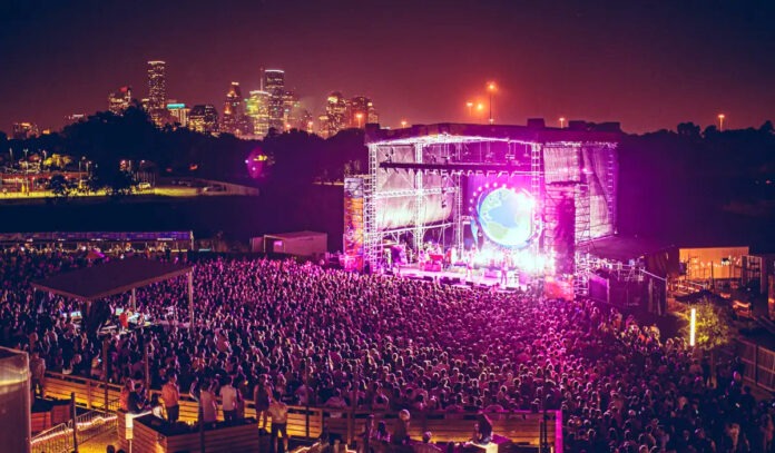 An aerial view of the White Oak Music Hall lawn stage with the Downtown Houston skyline in the background
