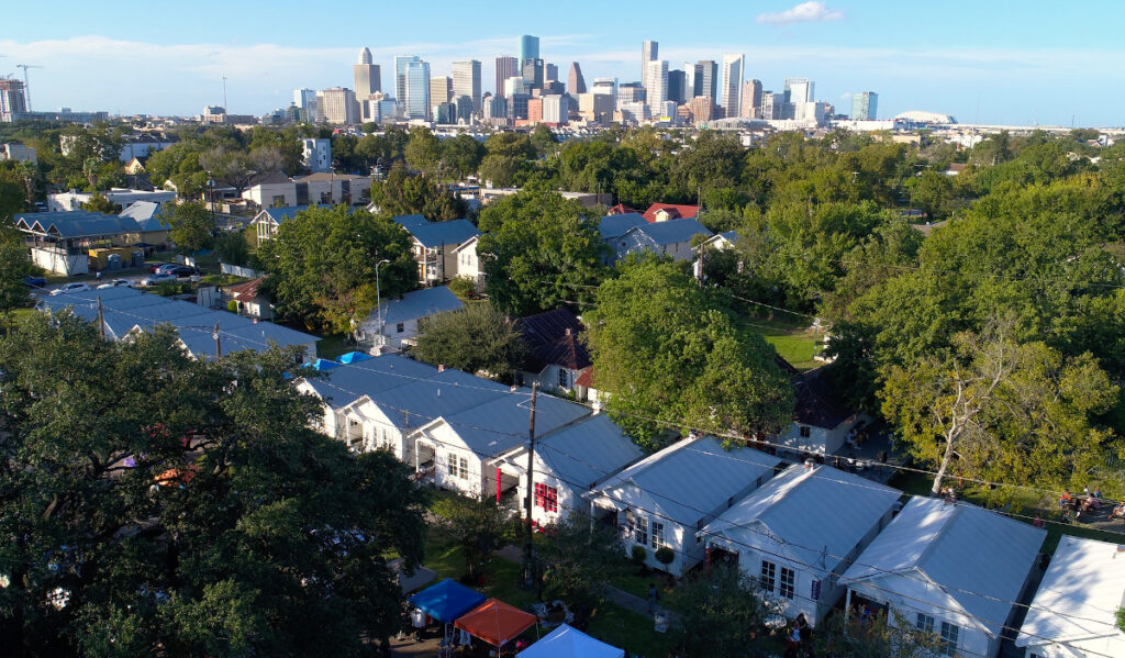 An aerial view of Project Row Houses with the Downtown skyline in the background