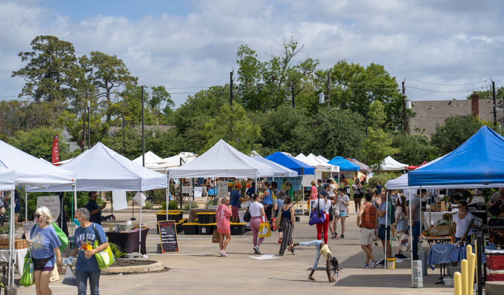 A bustling market with stalls, vendors, and families