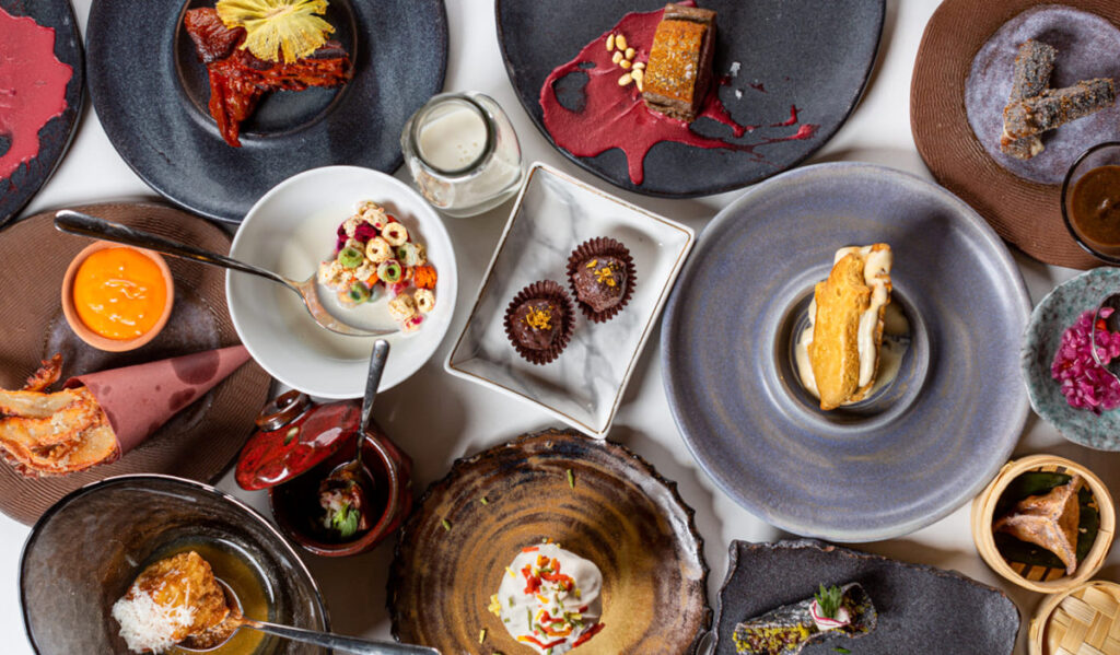 An overhead view of several dishes with entrees and sides