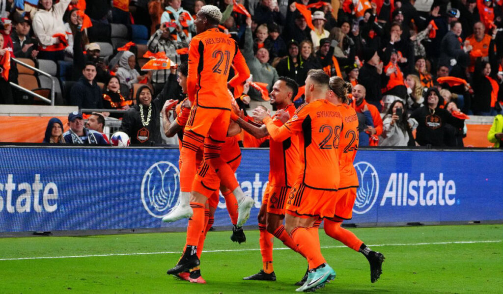 Dynamo players gather to celebrate after a goal