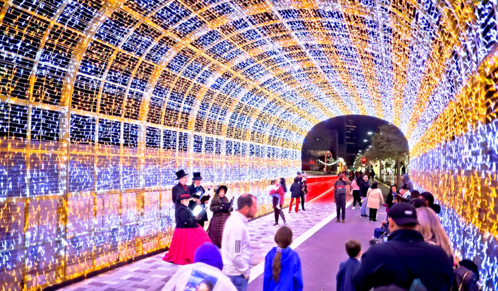 People walk through a tunnel of lights in Downtown Houston