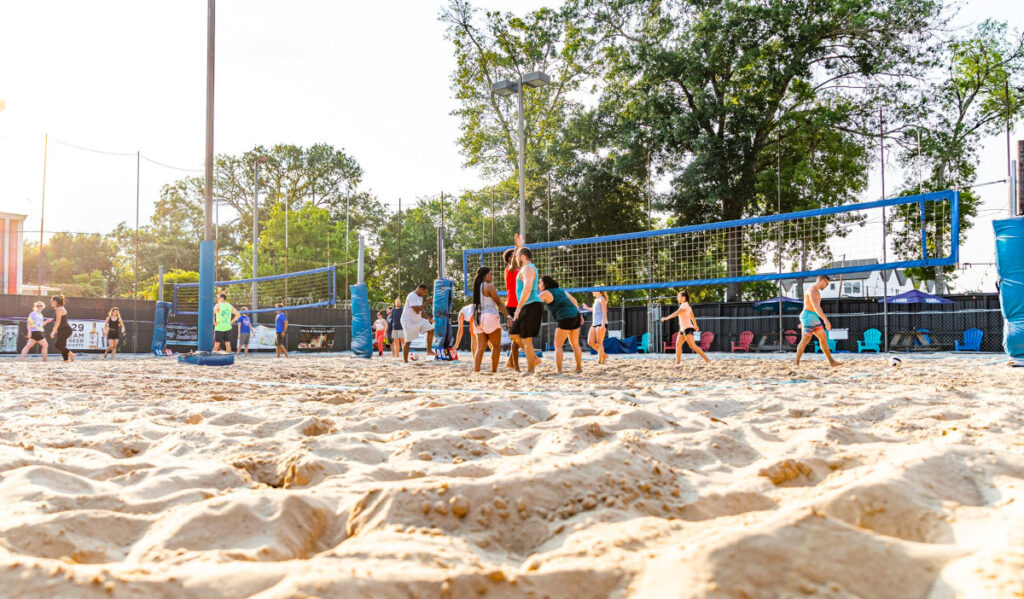 Teams playing sand volleyball