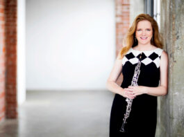 Alecia Lawyer posing while holding an oboe