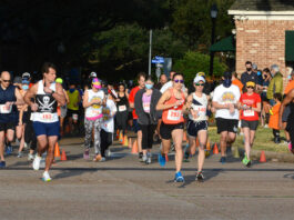 Rows of runners beginning an event in a neighborhood