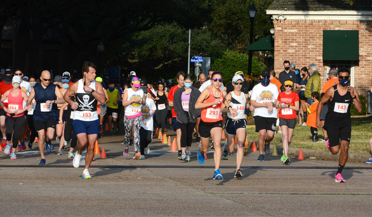 Rows of runners beginning an event in a neighborhood