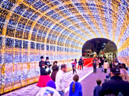 People walk through a tunnel of lights in Downtown Houston