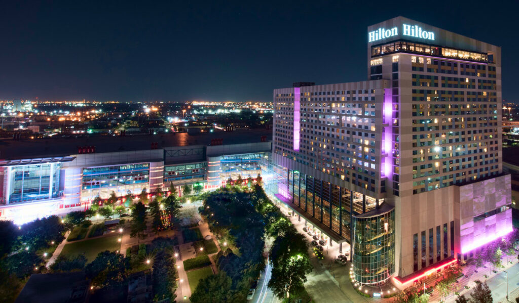 Hilton Americas-Houston with purple lights and a view of George R. Brown Convention Center