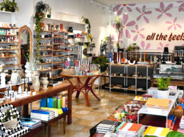 Interior of a shop with tables and shelves filled with products