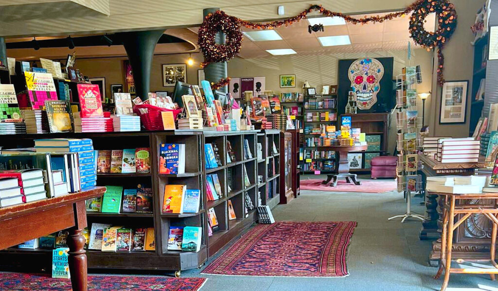 A brightly lit book store with rows of books for sale