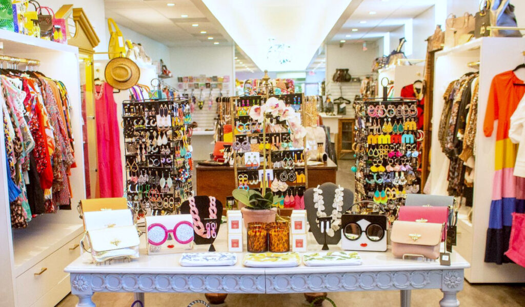 A brightly lit boutique with colorful accessories and clothing