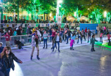 25 Things to do on Christmas Eve & Christmas Day in Houston Ice skaters glide with green-lit trees behind them