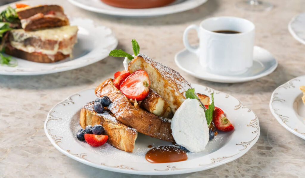 A plate of French toast with fruits on top