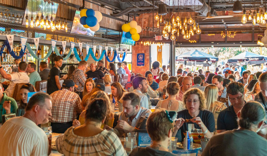 A bar interior filled with people at tables eating and drinking