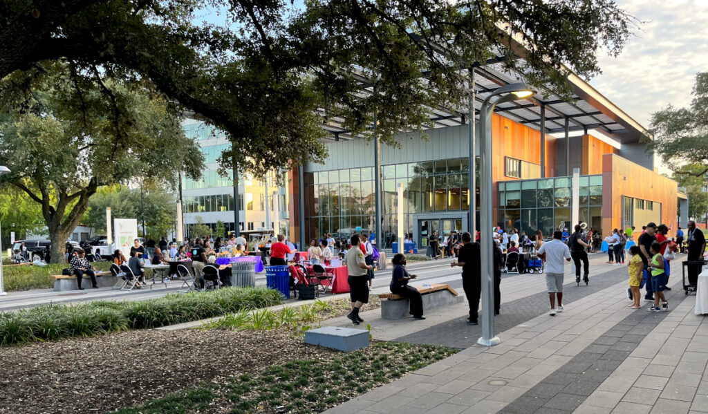 People gathered at Emancipation Park near a building