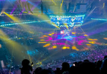 Houston Livestock Show & Rodeo 2024 Concert Lineup & Tickets A view of a Houston Rodeo concert from the upper level with yellow, pink and teal lights flashing