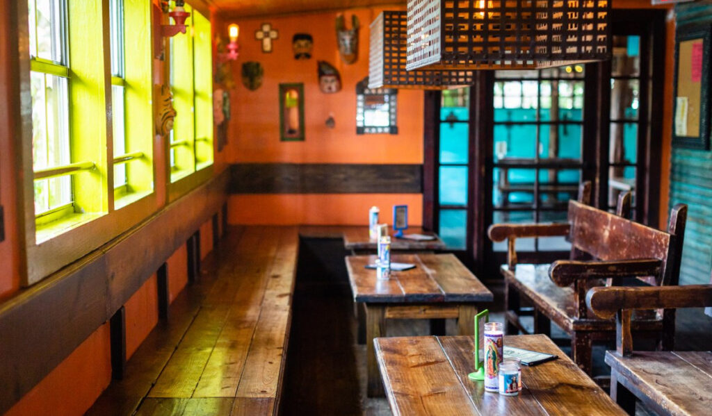 Interior of seating area at Under the Volcano with yellow, orange and teal walls