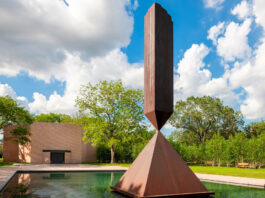 The "Broken Obelisk" sculpture sits foreground to the Rothko Chapel behind it