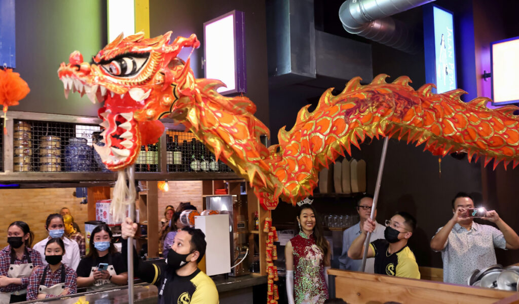 A Chinese Dragon dance is performed through a restaurant