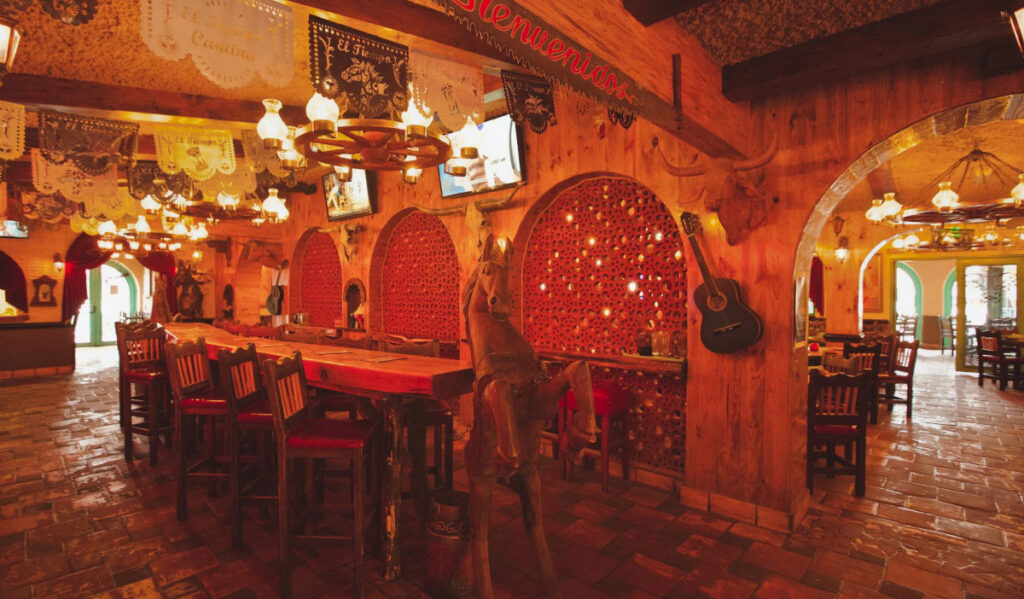 A wood-paneled dining room with a table and a wood-carved horse